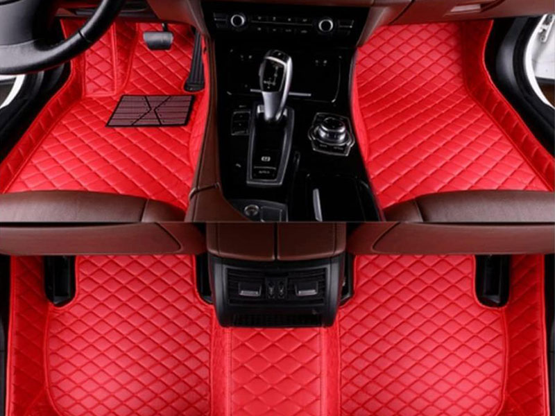 Red diamond-pattern luxury floor mats inside a car