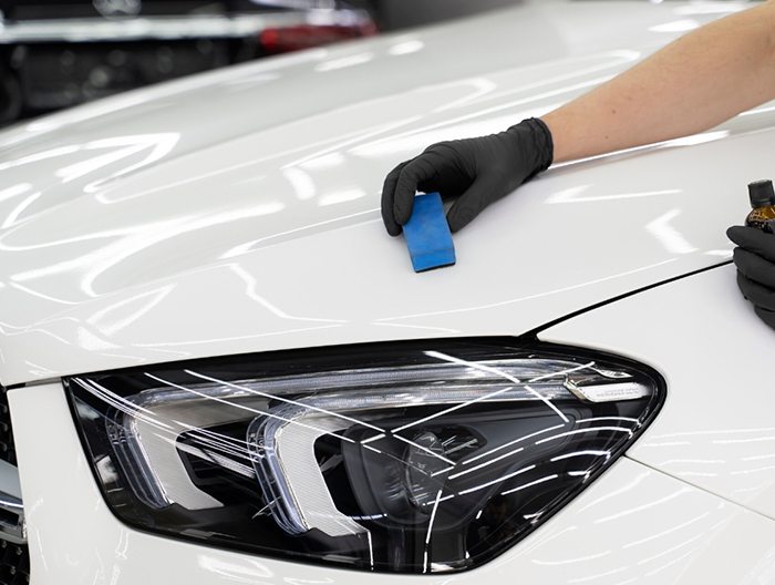 Applying a protective finish to a white car